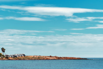 Scenic view of sea against cloudy sky