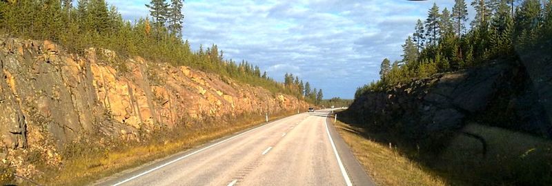 Road amidst mountains against sky