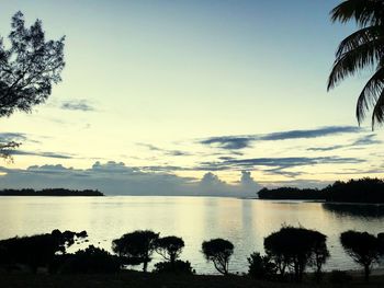 Scenic view of lake against sky at sunset