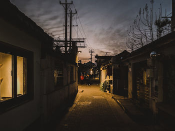 Street amidst buildings in city against sky