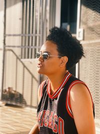 Young woman wearing sunglasses standing outdoors