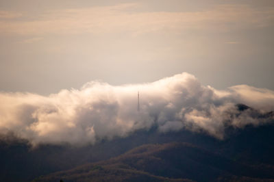 Low angle view of clouds over mountain