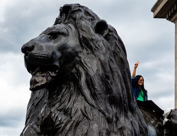 Low angle view of woman statue against sky