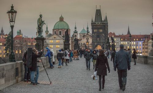 People at temple against sky in city