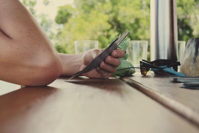 Low section of woman working on table