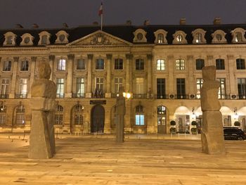 Illuminated building against sky at night