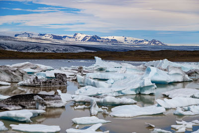 Scenic view of frozen lake against sky during winter