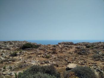 Scenic view of desert against clear blue sky