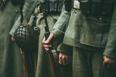 Midsection of soldiers standing in row