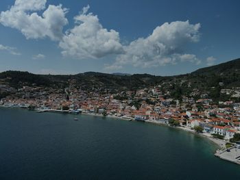 High angle view of townscape by sea against sky