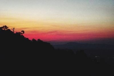 Scenic view of silhouette mountain against romantic sky