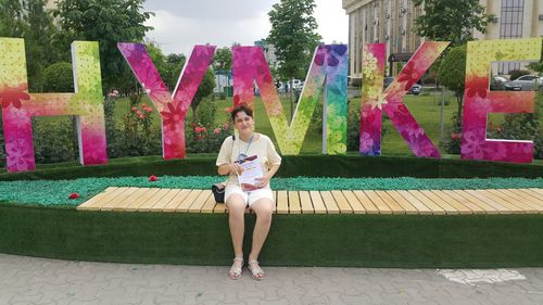 Full length of young woman sitting on steps