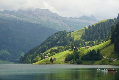 Scenic view of lake and mountains against sky