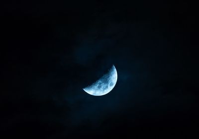 Low angle view of half moon against sky at night