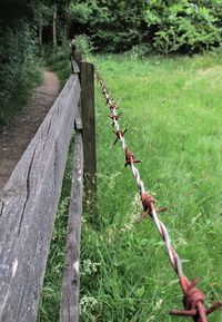 Barbed wire fence on field