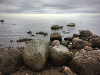 Rocks in sea against sky