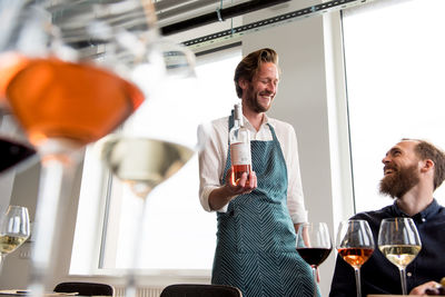 Bartender and customer laughing in tasting room