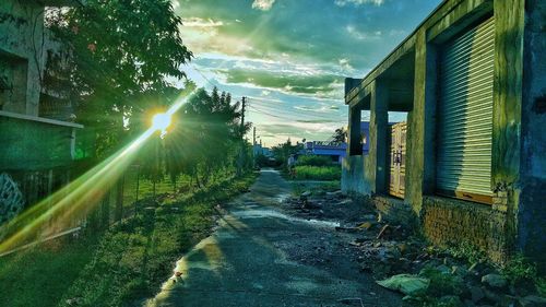 Road amidst buildings against sky