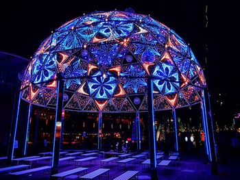 Illuminated ferris wheel at night