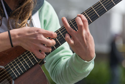 Close-up of hands playing guitar