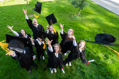 High angle view of friends standing on field