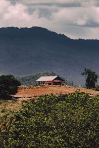 House on mountain against sky