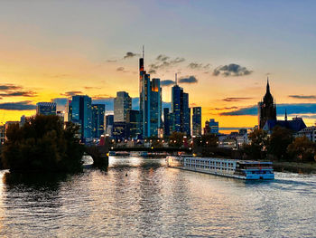 River with buildings in background at sunset