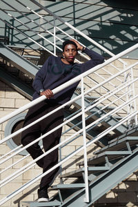 Low angle view of young man standing on escalator