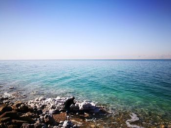 Scenic view of sea against clear blue sky