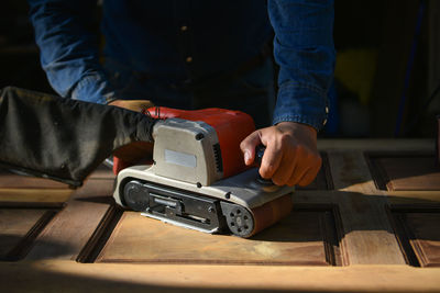 Midsection of man working on table