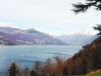 Scenic view of sea and mountains against sky