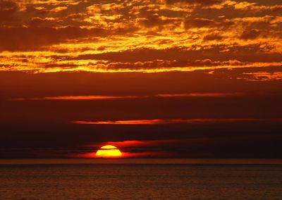 Scenic view of sea against romantic sky at sunset