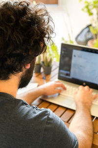 Midsection of businessman photographing laptop