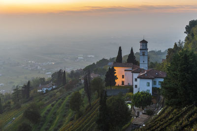 Sunset from the cormons hill. among fog, vineyards and fiery colors. italy