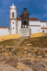 Statue in temple against sky