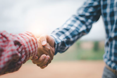 Midsection of man holding hands