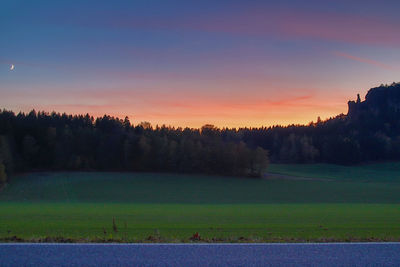 Scenic view of field against sky during sunset