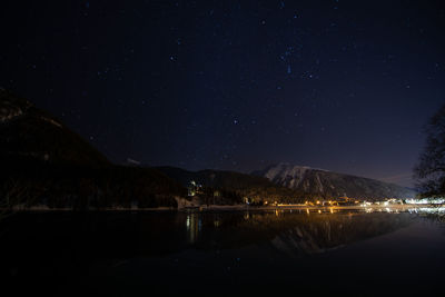 Illuminated mountains against sky at night