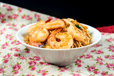 Close-up of shrimps in bowl on tablecloth