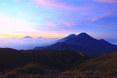 Scenic view of mountains against sky at sunset