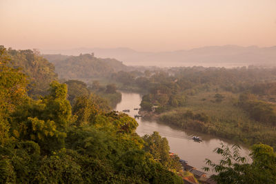 High angle view of river by trees against sky