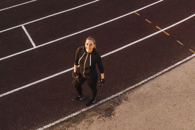 Portrait of woman standing in stadium