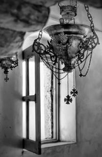 Low angle view of lamp hanging on wall in old building