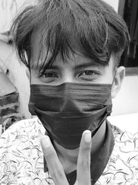 Close-up portrait of boy covering face