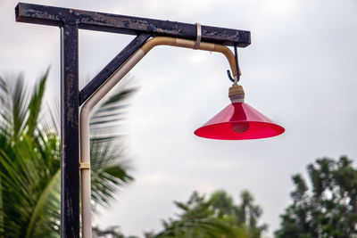 Low angle view of decoration hanging on tree against sky