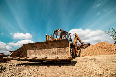 Abandoned vehicle against blue sky