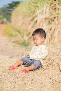 Boy sitting on field