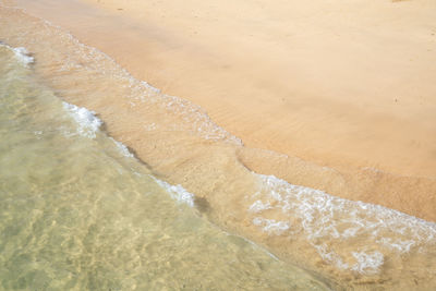 High angle view of waves rushing towards shore