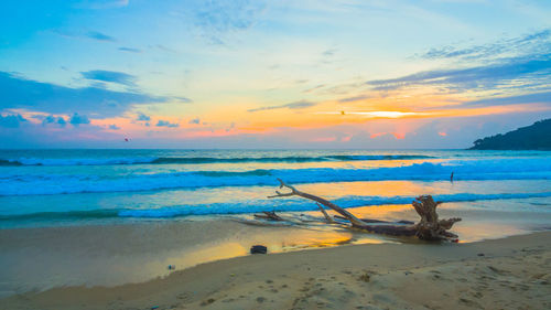 Scenic view of beach against sky during sunset