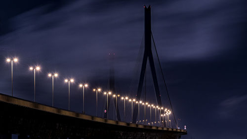 Low angle view of illuminated bridge against sky at night